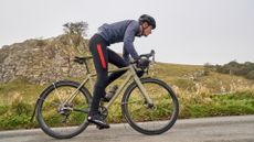 Male cyclist wearing cycling overshoes while on a winter road ride