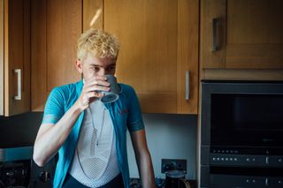 cyclist drinks a coffee before heading out for a ride